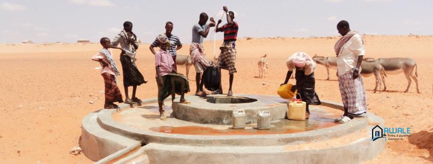 People getting water from hand-dug well for prople